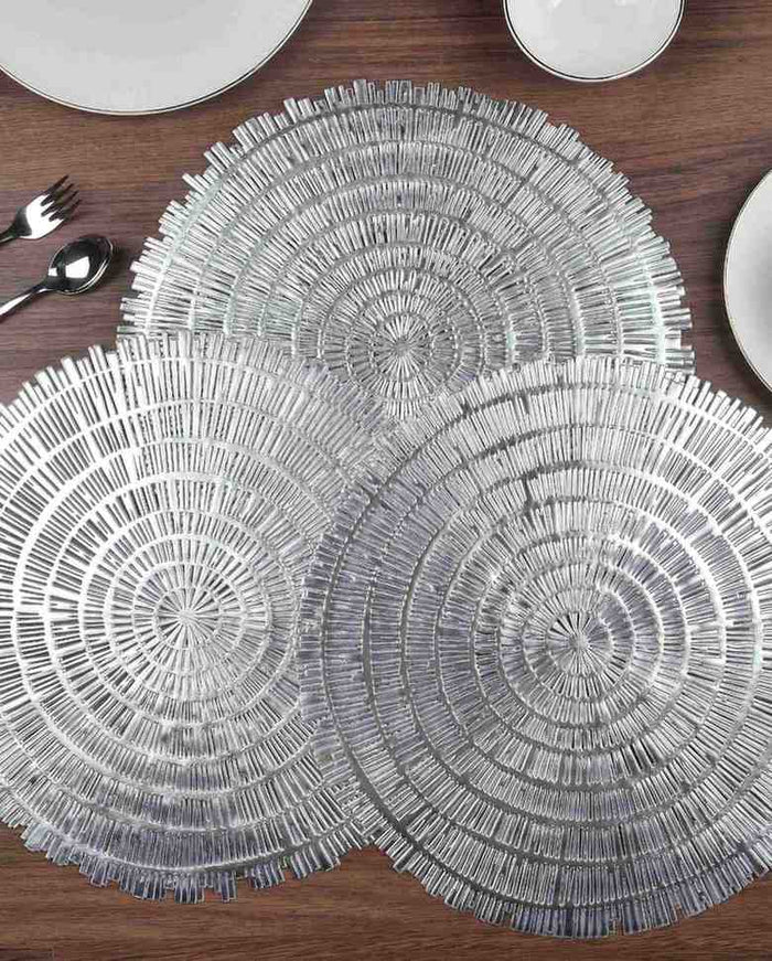 Pair of round woven metallic table mats with concentric circular fringe, silver tone