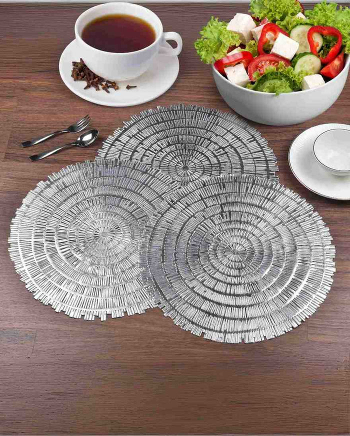 Set of two round woven metallic table mats with concentric fringe, silver tone