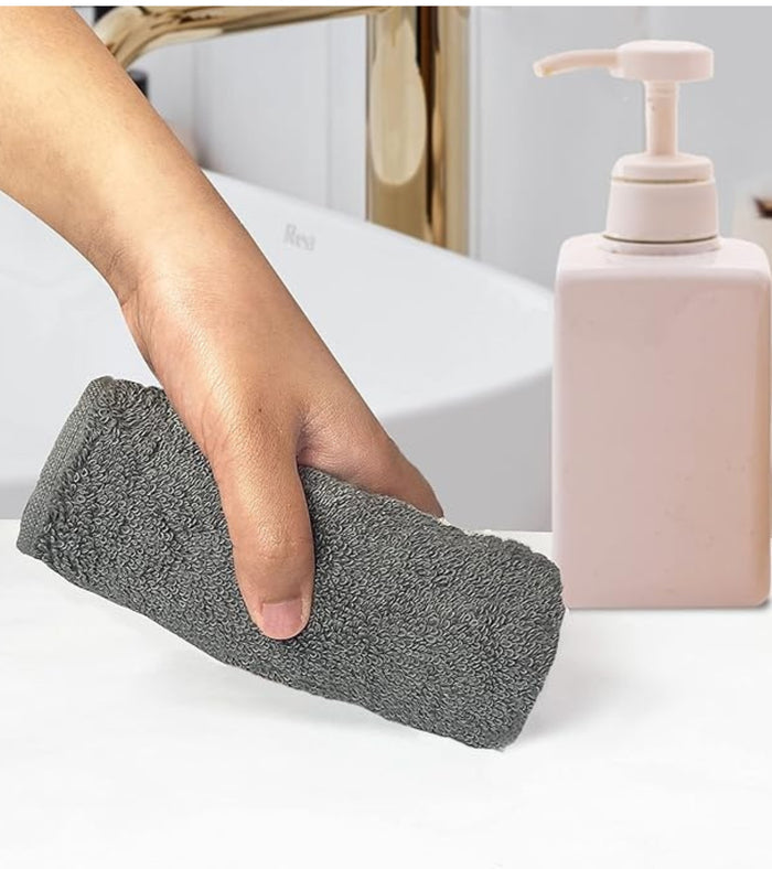 Grey plush hand towel being used to dry hands