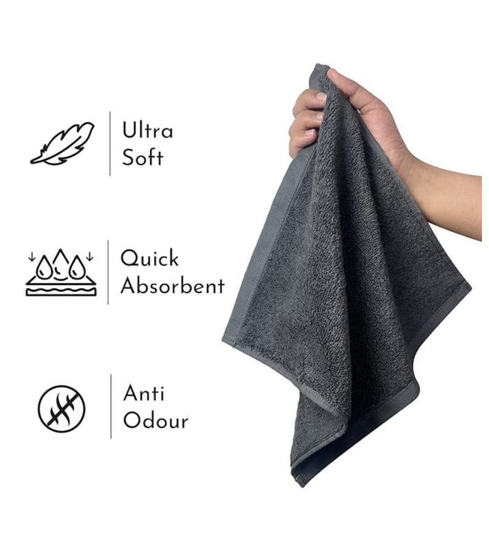 Grey plush hand towel held up by two hands