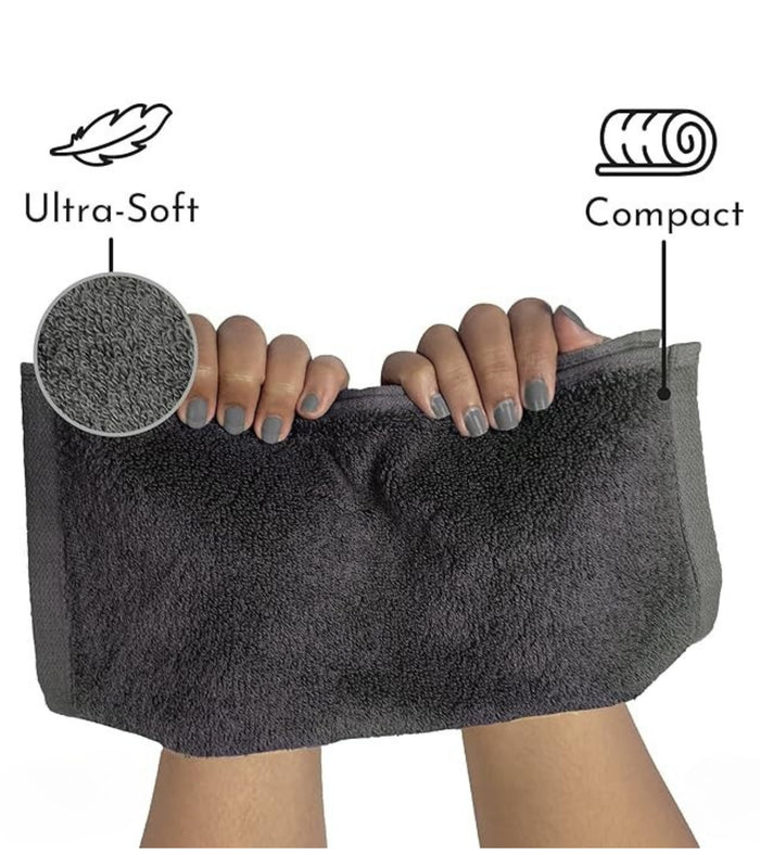 Grey plush compact hand towel, squeezed to show thickness