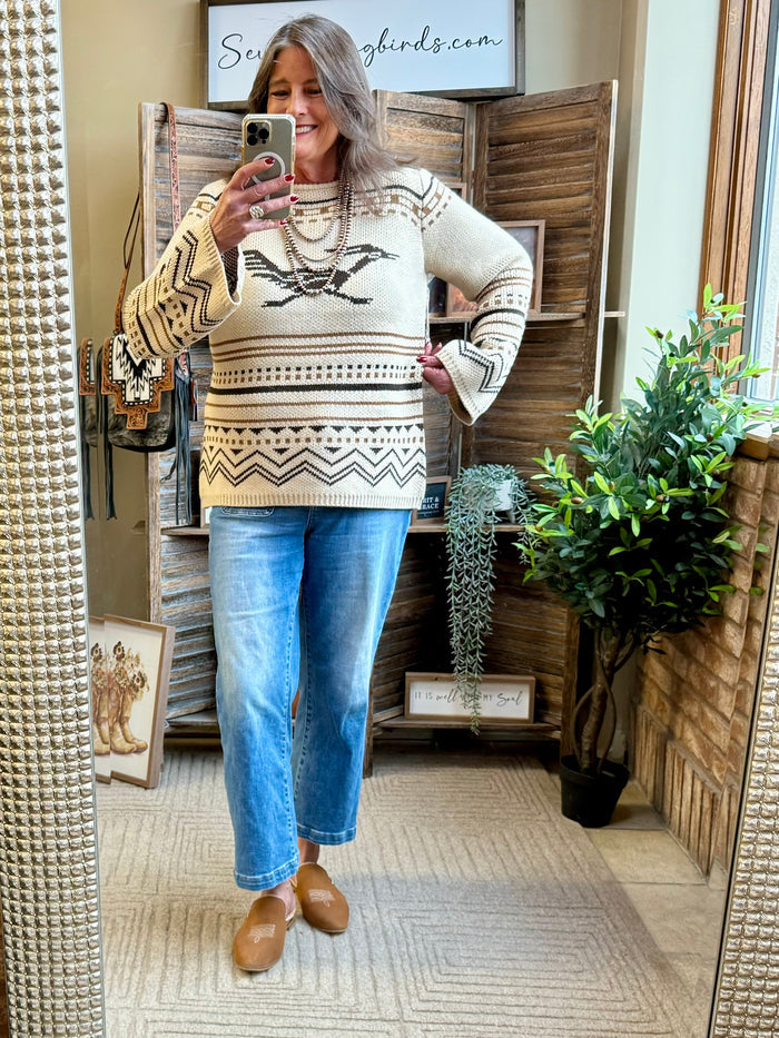 Crew neck sweater with tan knit and black geometric yoke, banded cuffs and hem.