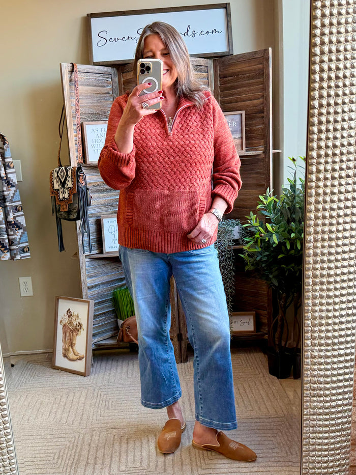 Rust quarter-zip cable-knit sweater with kangaroo pocket, long sleeves, ribbing