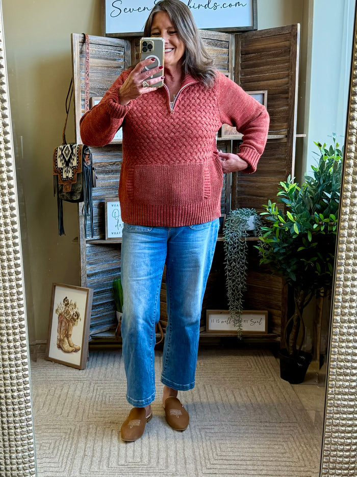Rust cable-knit quarter-zip sweater with front pocket and ribbed cuffs