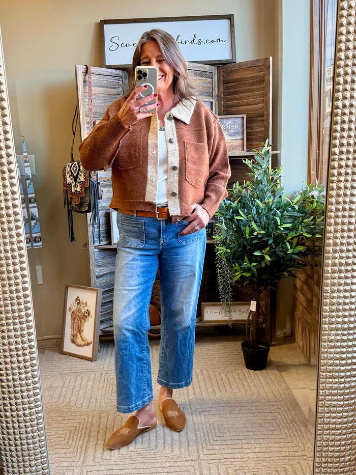 Rust-brown collared cardigan with cream inner placket, button front, and long sleeves