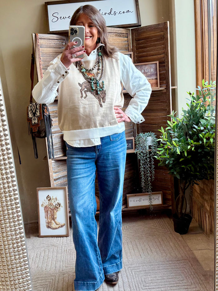 Cream sweater vest with western saddle bronc horse-and-rider graphic, front view