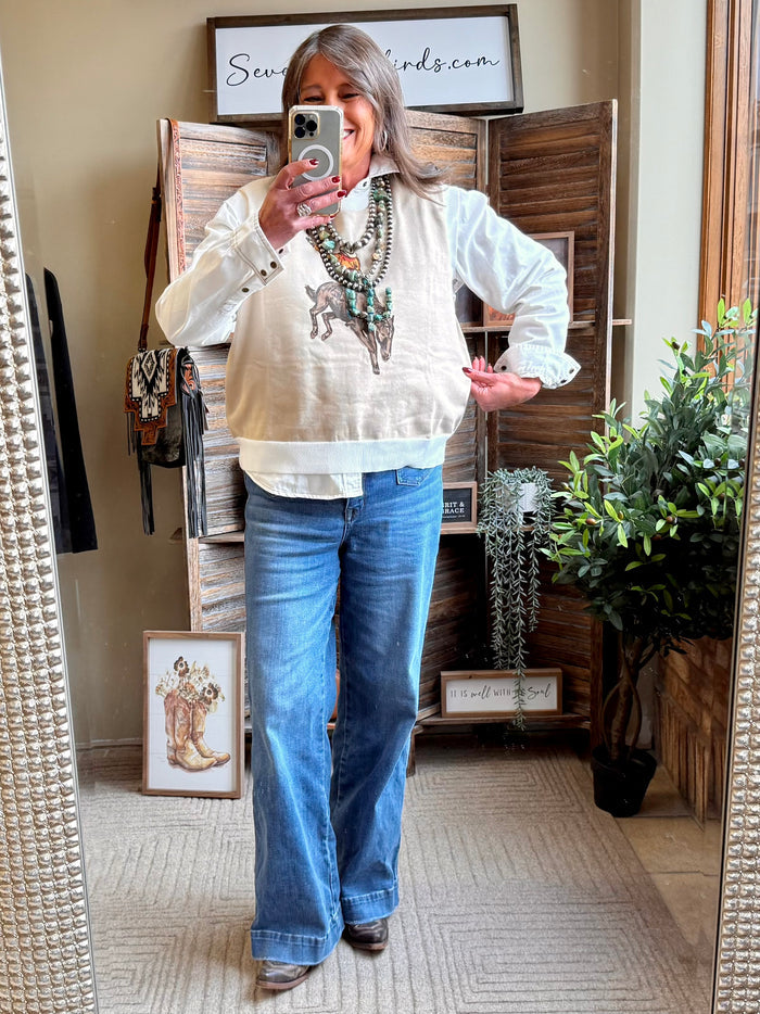 Cream sweater vest with western saddle bronc horse-and-rider graphic