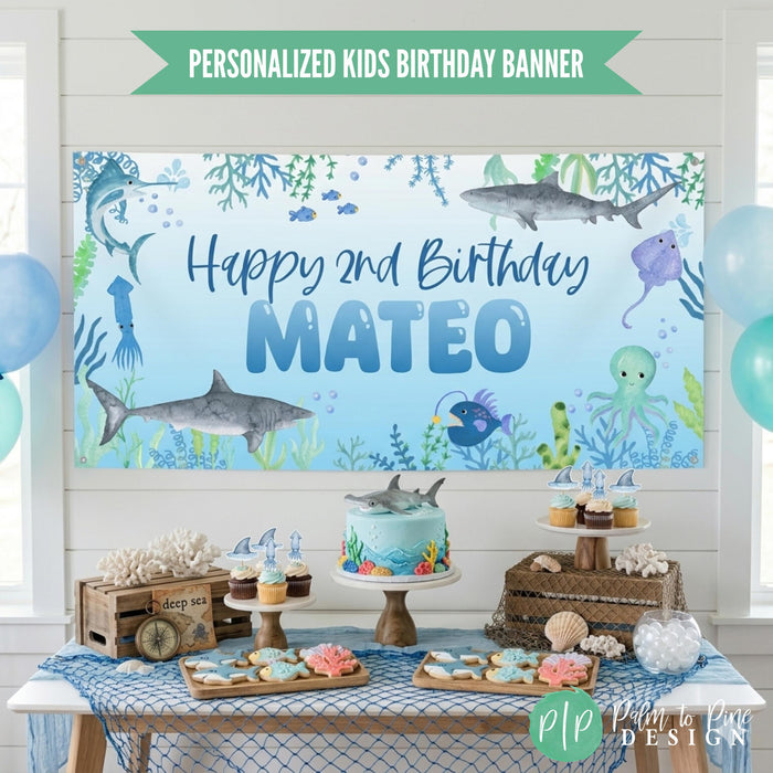 Shark themed birthday banner with ocean animals at kids birthday party