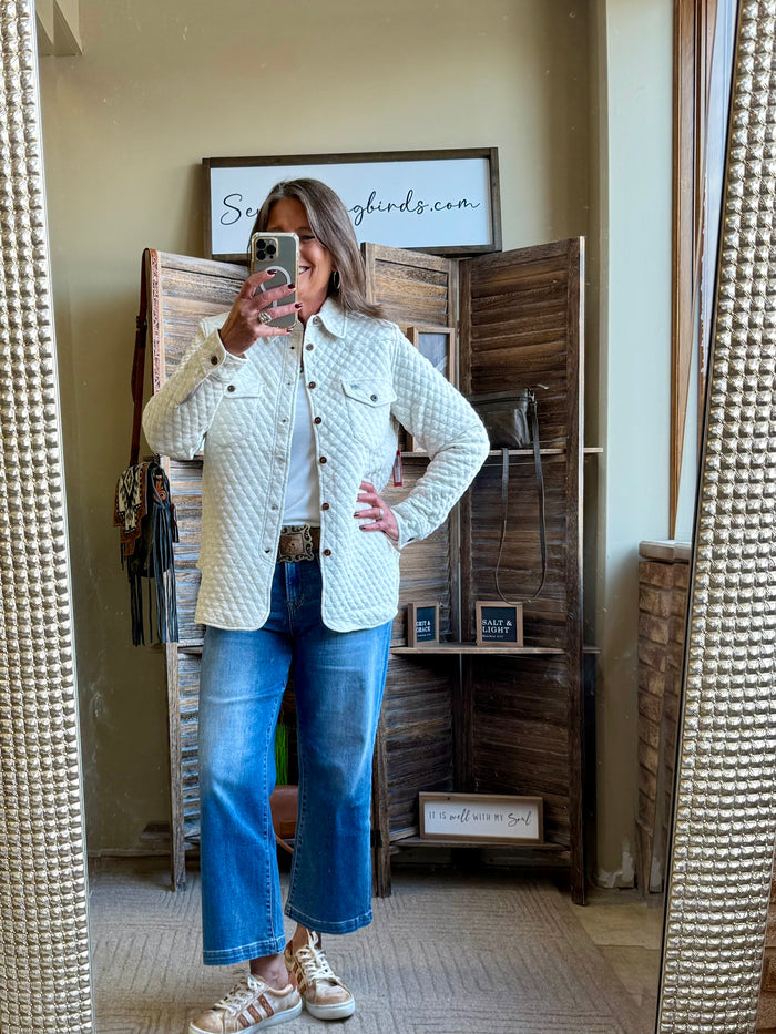 Beige quilted knit button-front shirt with collar and chest pockets (angled front view)