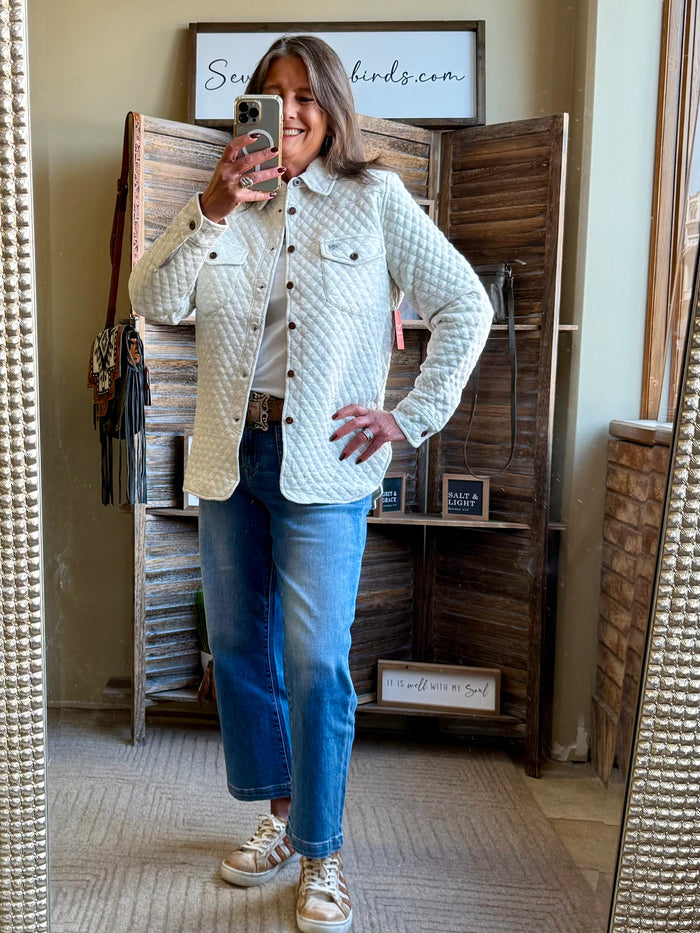 Beige quilted knit button-front shirt with two chest pockets and long sleeves