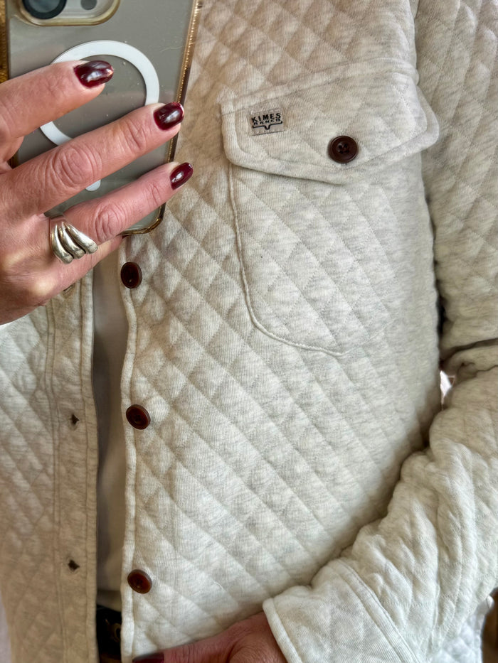 Beige quilted knit shirt front with button placket and chest pocket with button