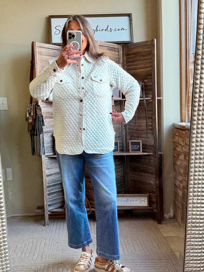 Beige quilted knit button-front shirt with collar and two chest pockets (front view)
