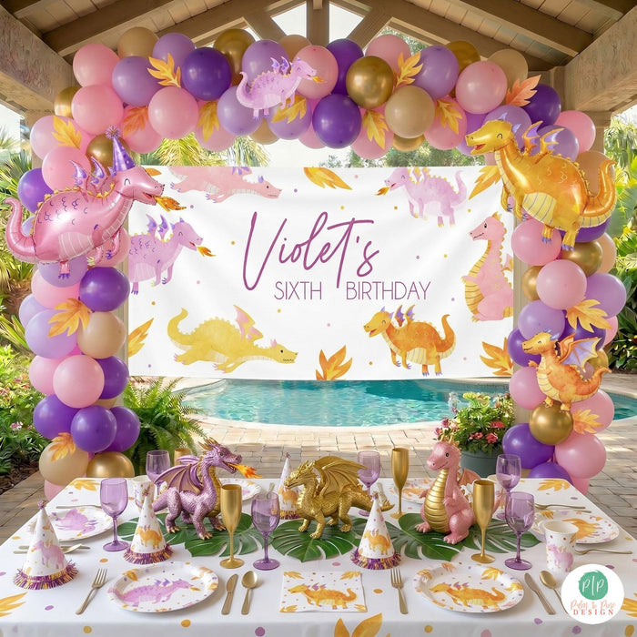 Girls dragon birthday party decorations and personalized banner with dragon balloon garland and matching tablescape