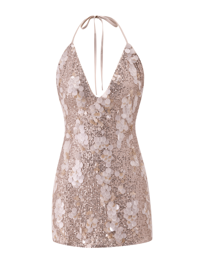 The ZANA MINI DRESS by TIGERMIST is a gold, sleeveless mini dress with a halter and deep V-neckline, adorned with shiny sequins and large circular embellishments.